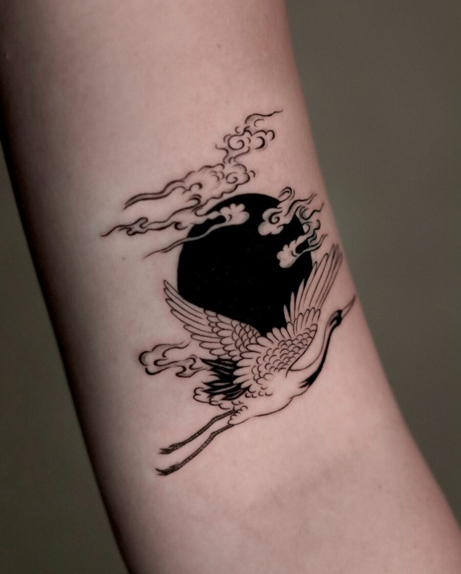 Elegant crane tattoo with clouds and moon Tattoo on skin