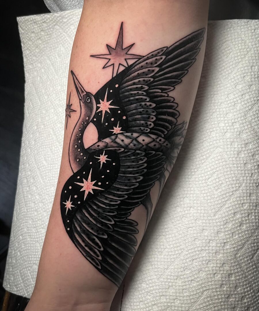 Elegant crane tattoo with cosmic elements Tattoo on skin