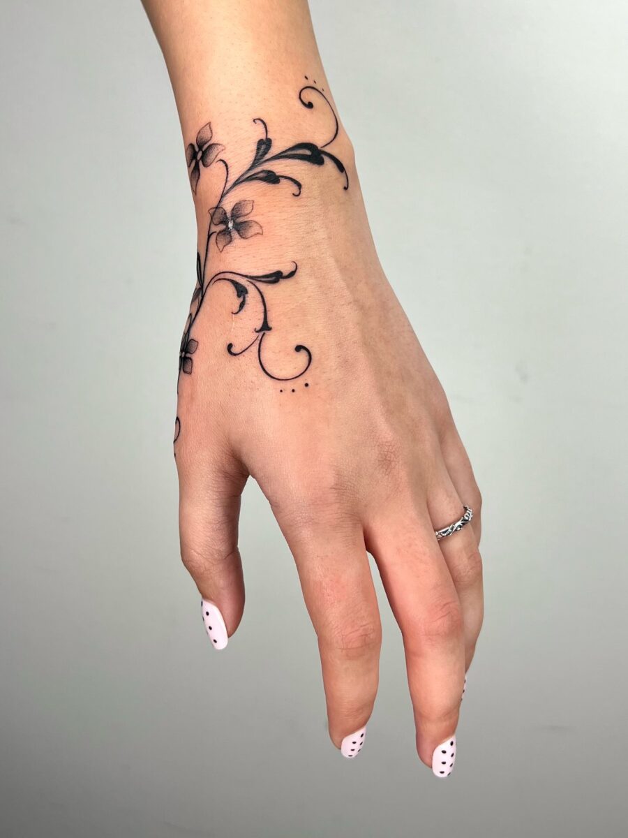 Elegant floral tattoo design on the hand Tattoo on skin
