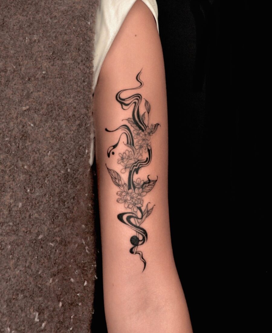 Elegant floral tattoo with flowing designs. Tattoo on skin
