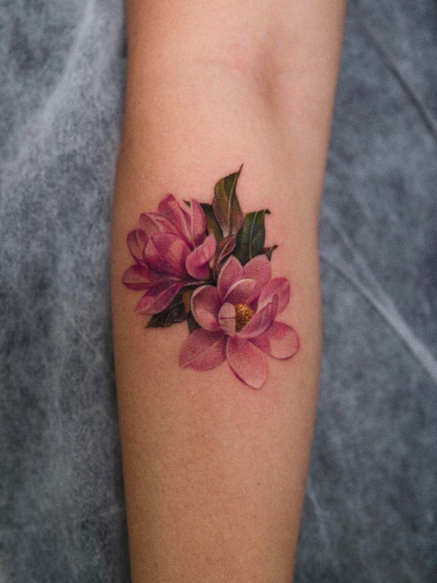 Elegant magnolia covers flaws beautifully Tattoo on skin