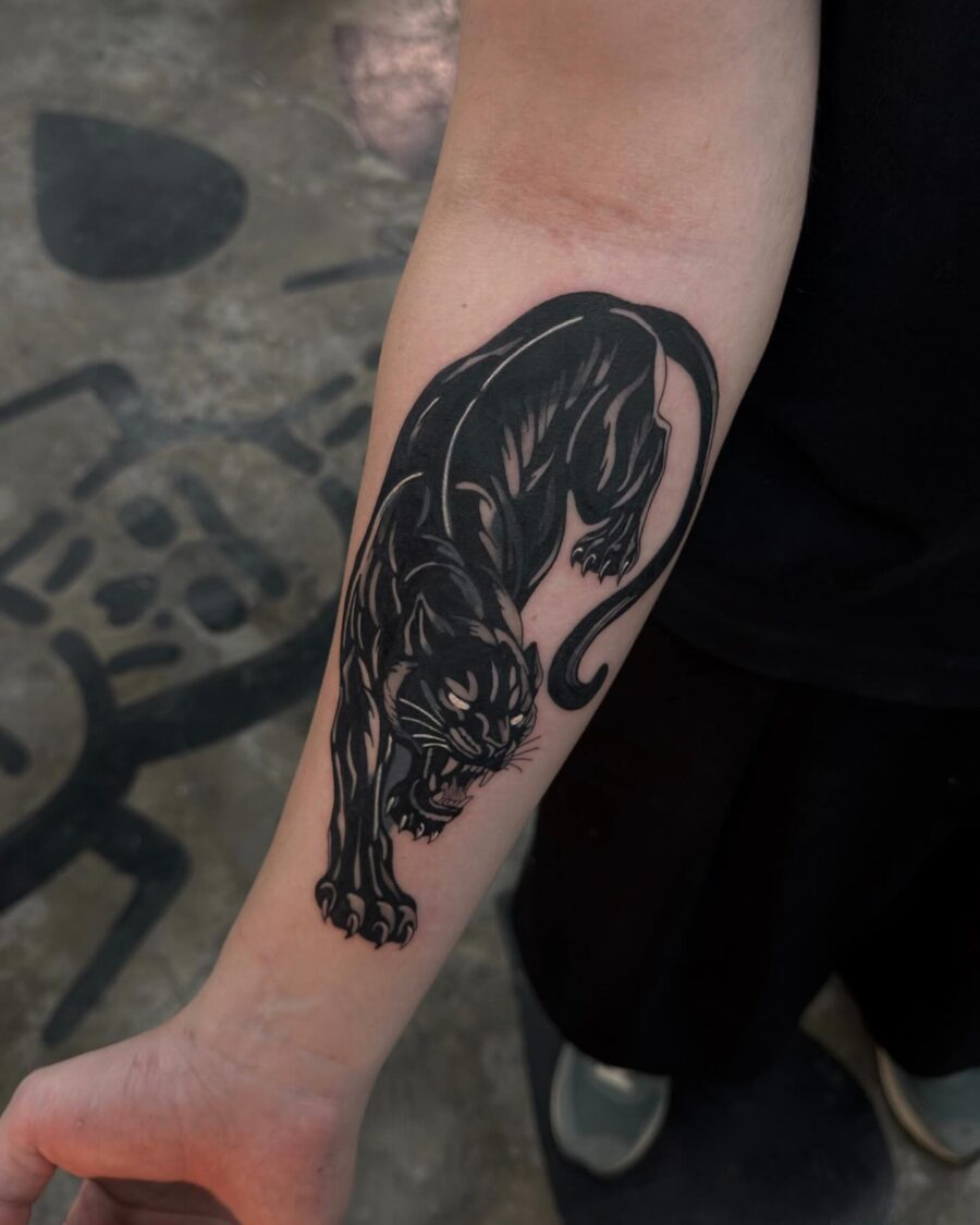 Striking black panther tattoo design on arm Tattoo on skin