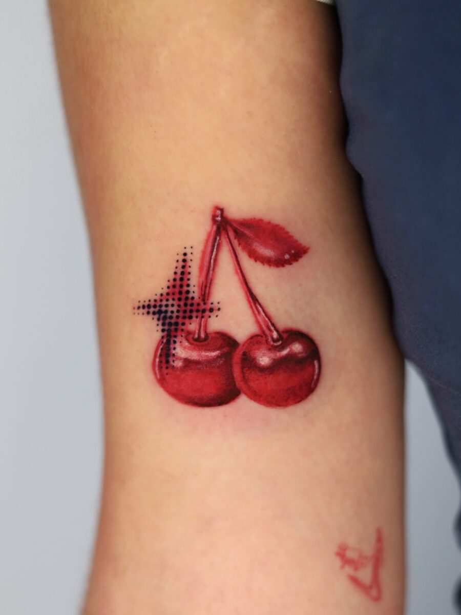 Vibrant Cherry Tattoo with Bold Detailing Tattoo on skin