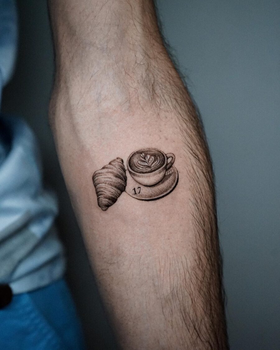 Charming croissant and coffee tattoo on arm Tattoo on skin