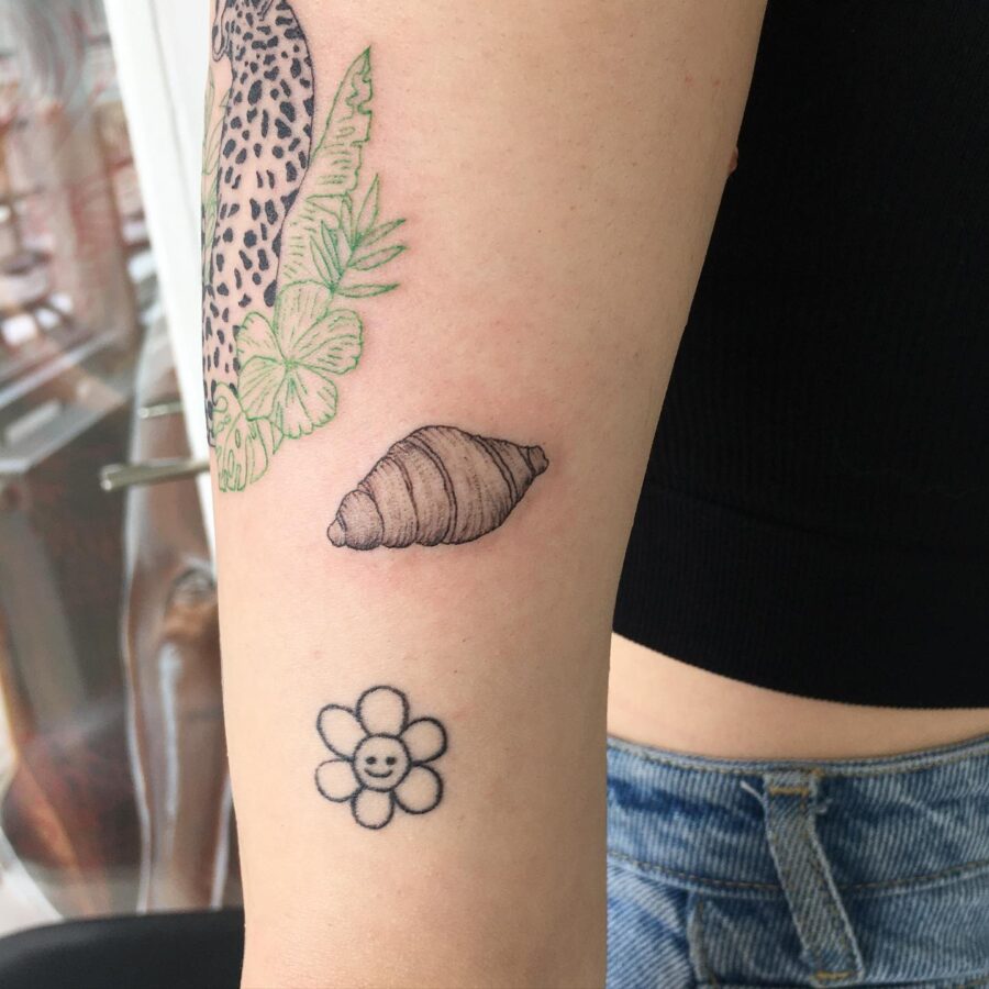 Charming croissant and flower tattoo combo Tattoo on skin