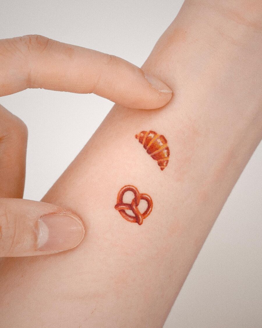 Charming Croissant and Pretzel Hand Tattoos Tattoo on skin