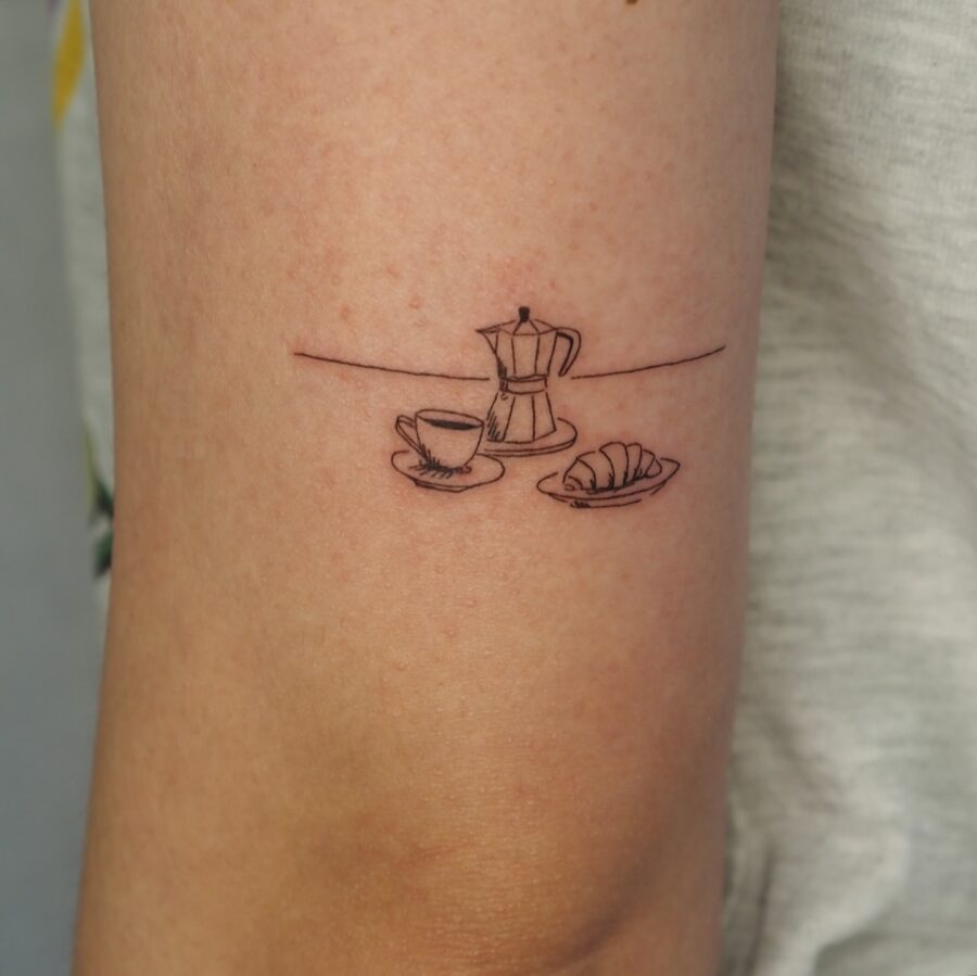 Charming croissant tattoo with coffee and moka pot Tattoo on skin