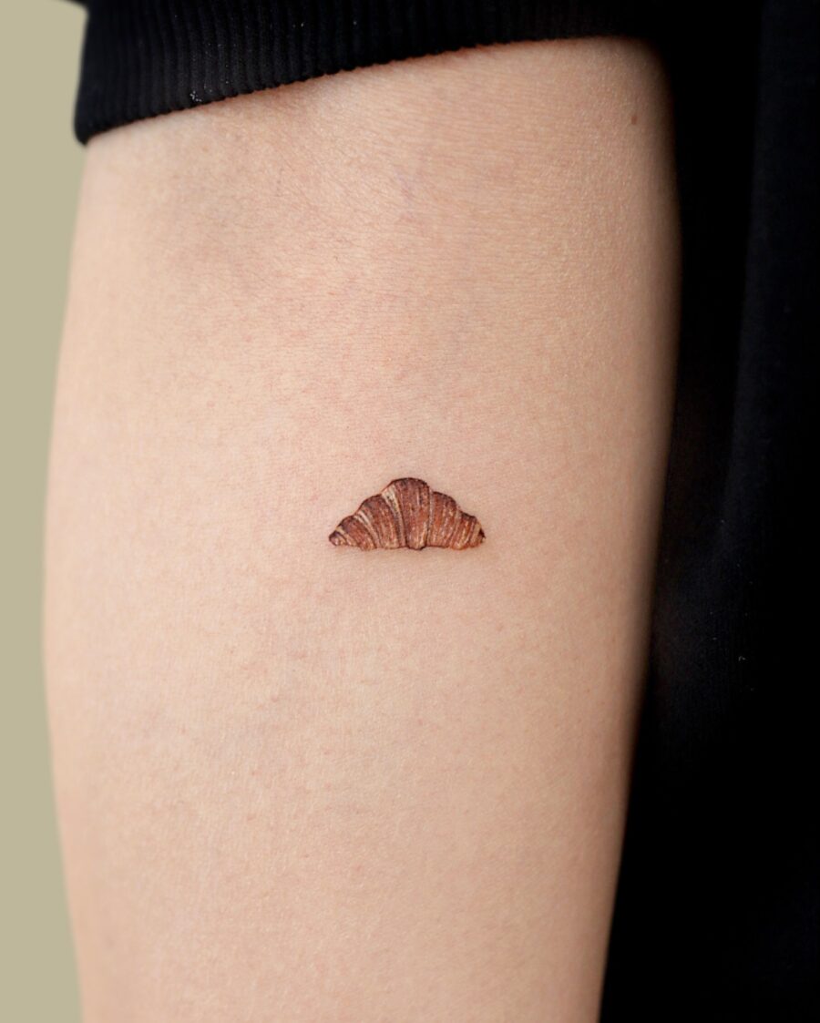 Charming croissant tattoo with rich details Tattoo on skin