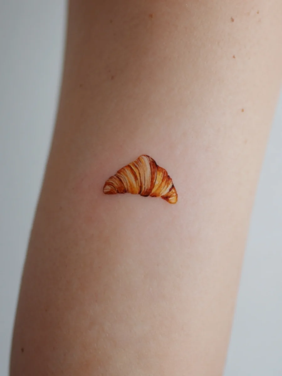 Charming minimal croissant tattoo on arm Tattoo on skin