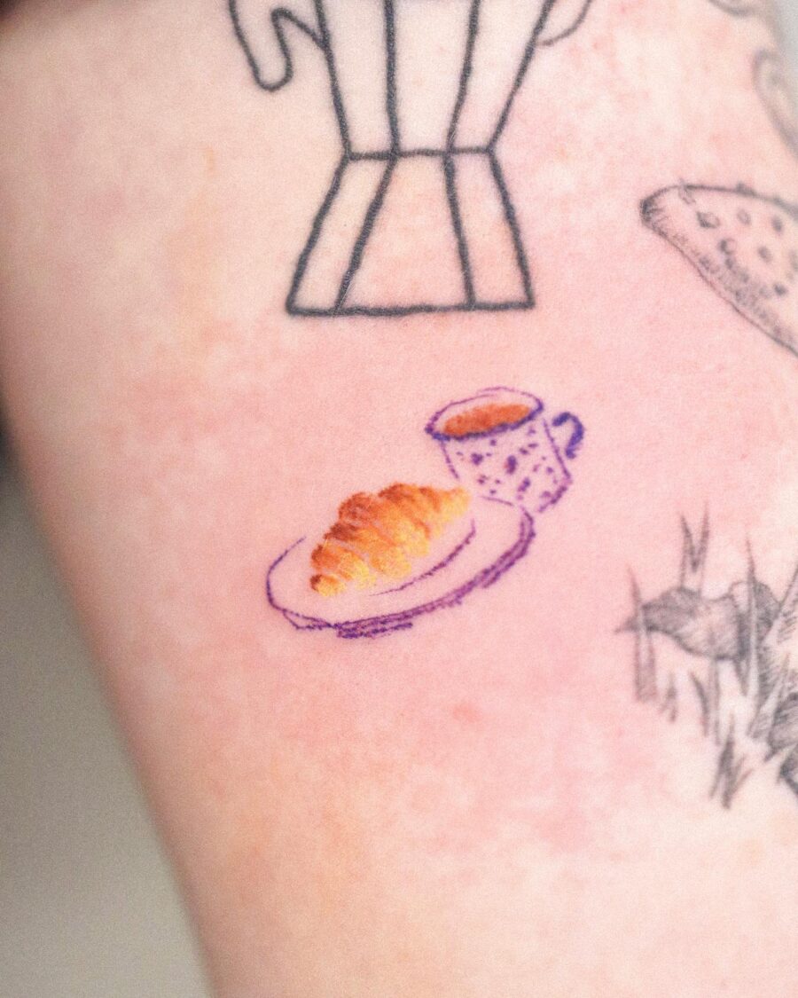Delightful croissant and coffee tattoo design Tattoo on skin