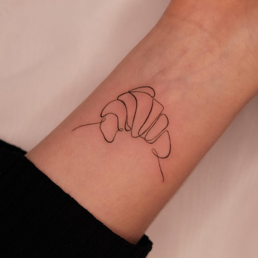 Elegant line art croissant tattoo design Tattoo on skin