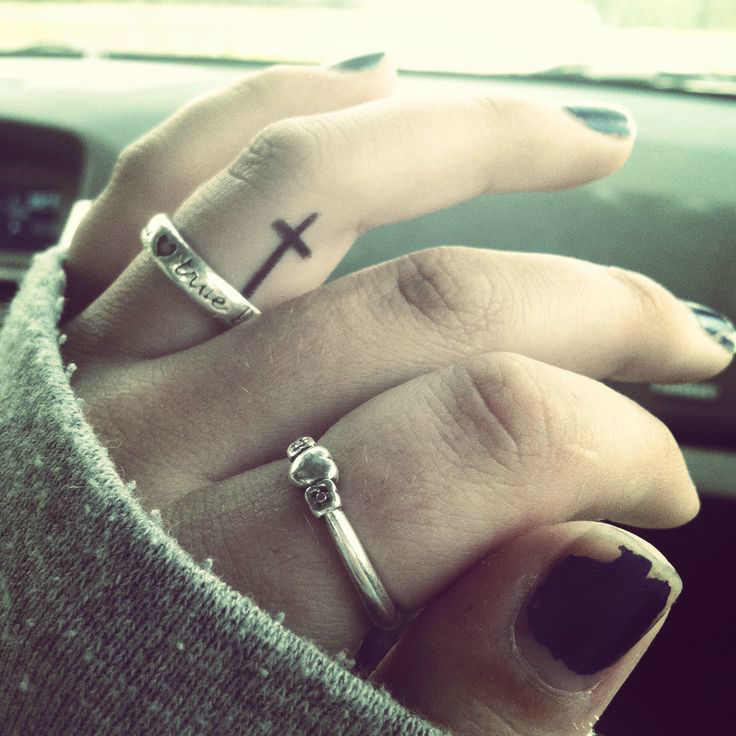 small cross tattoo Tattoo on skin