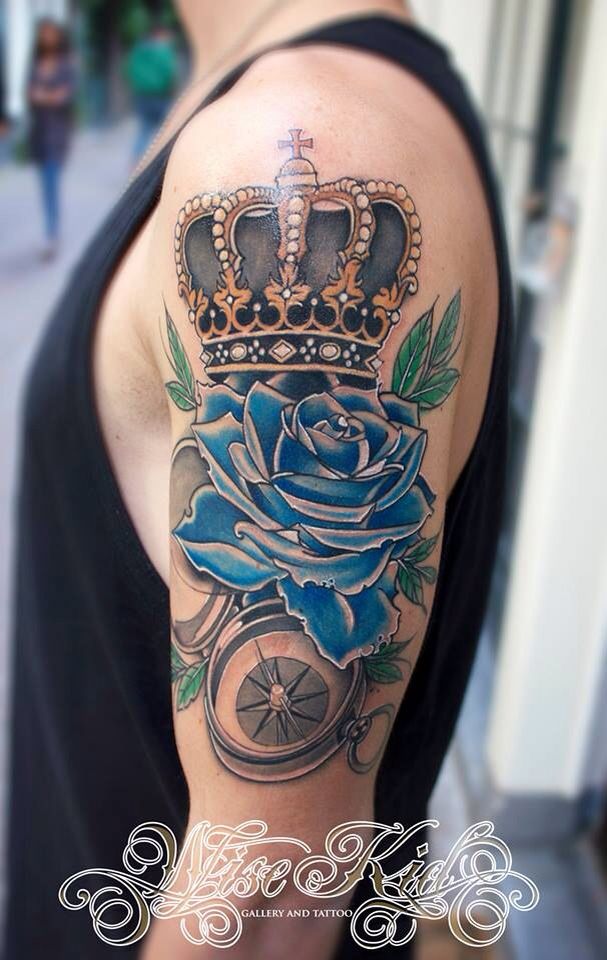 Crown and Compass Tattoo with Blue Roses Tattoo on skin