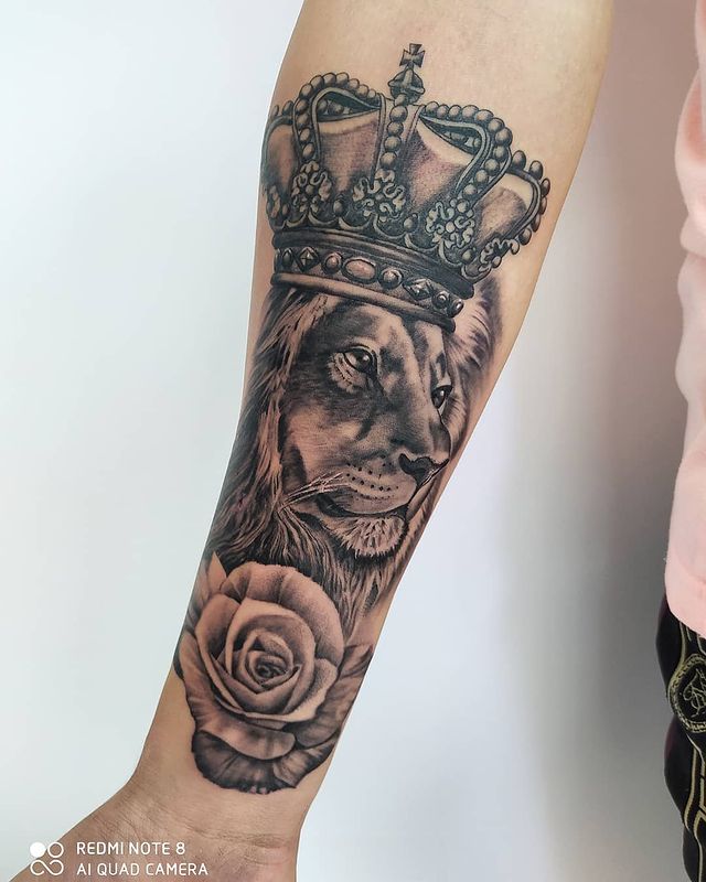 Lion King Ink with Botanical Details Tattoo on skin