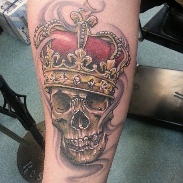 Skull Ink with Gold and Red Coronet Tattoo on skin