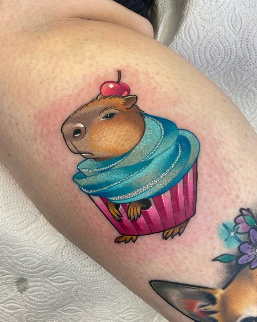 Adorable cupcake tattoo featuring a capybara Tattoo on skin