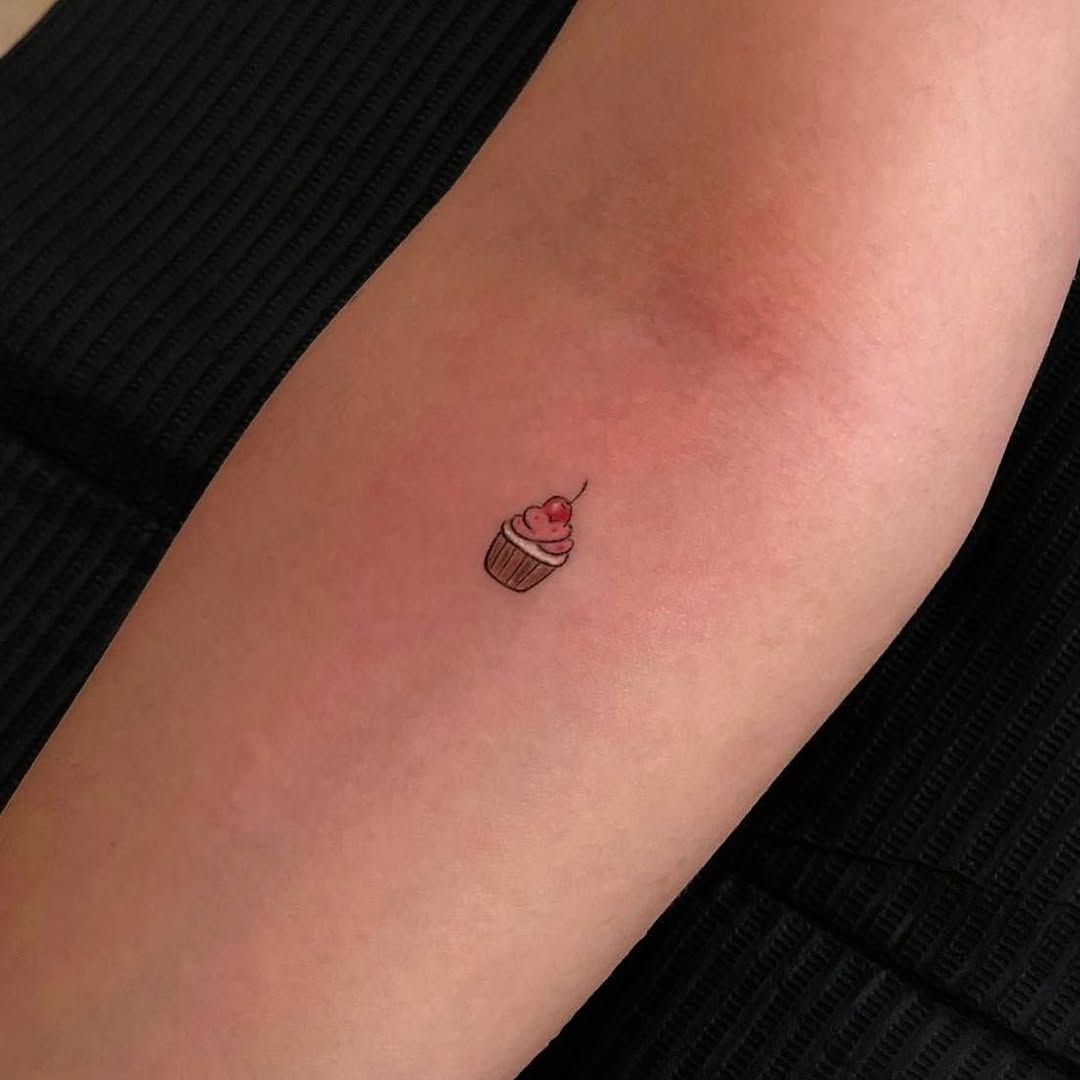Adorable small cupcake tattoo on the arm Tattoo on skin