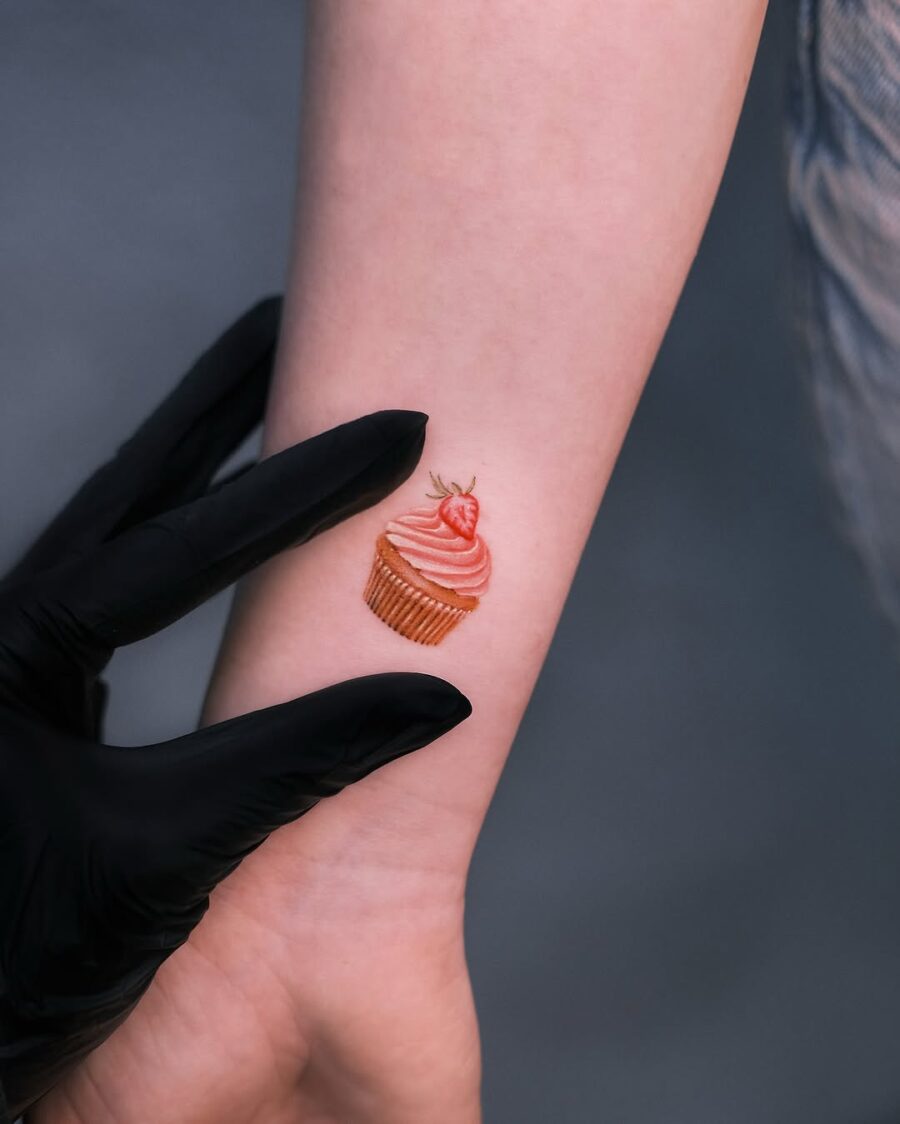 Charming cupcake tattoo on a delicate wrist Tattoo on skin