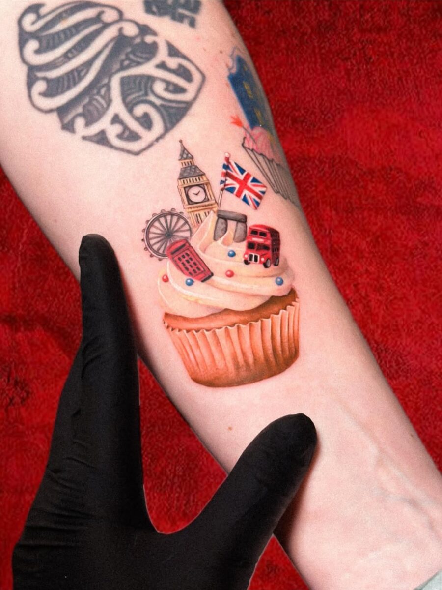 Charming cupcake tattoo with London landmarks Tattoo on skin