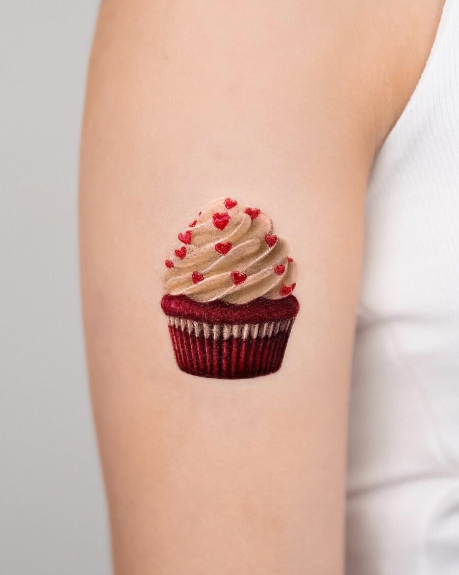 Colorful cupcake tattoo with charming heart details Tattoo on skin