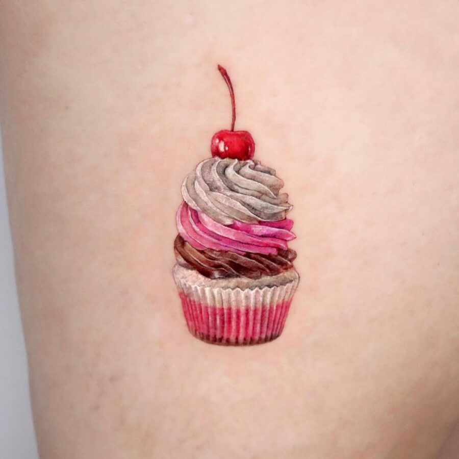 Delightful 3D cupcake tattoo with cherry Tattoo on skin