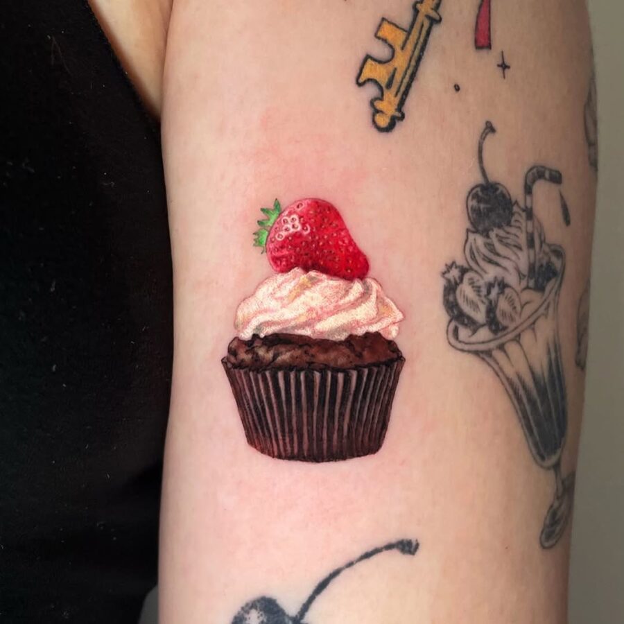 Delightful Cupcake Tattoo with Strawberry Element Tattoo on skin