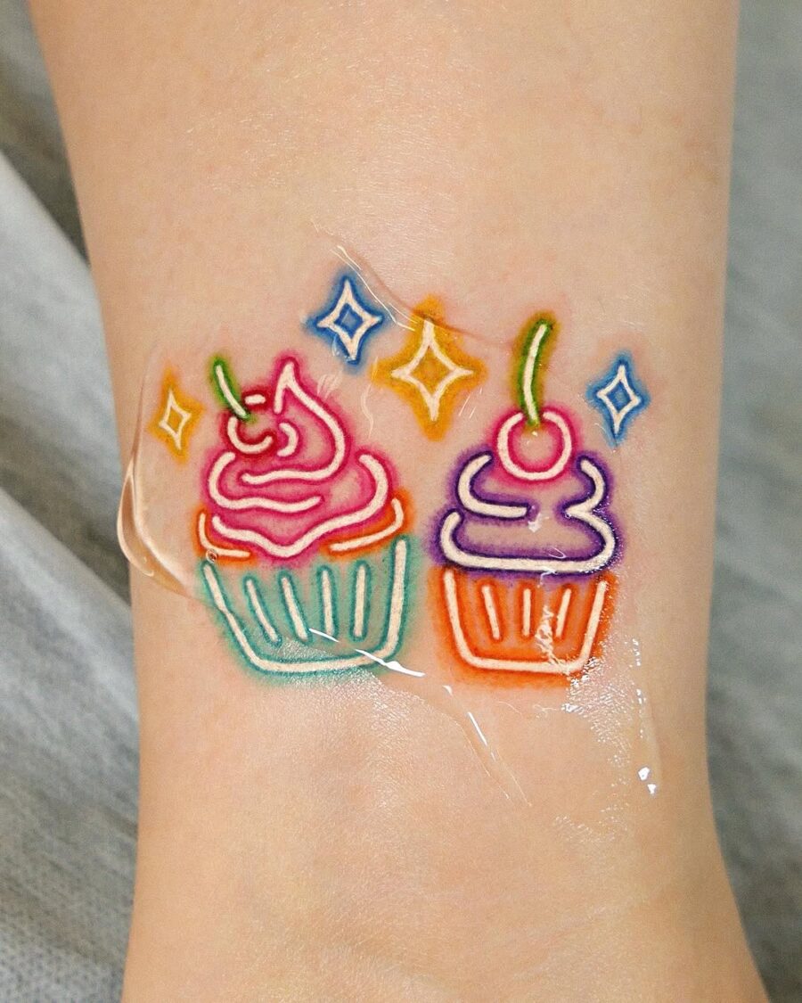 Delightful dual cupcake tattoo design Tattoo on skin
