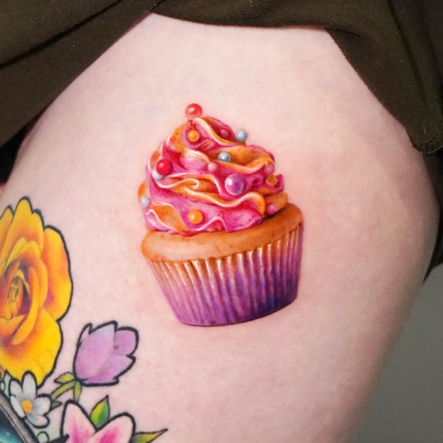 Vibrant cupcake tattoo showcasing sweet creativity Tattoo on skin