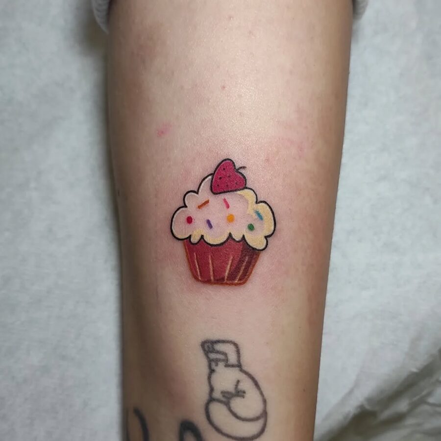 Vibrant cupcake tattoo with playful sprinkles Tattoo on skin