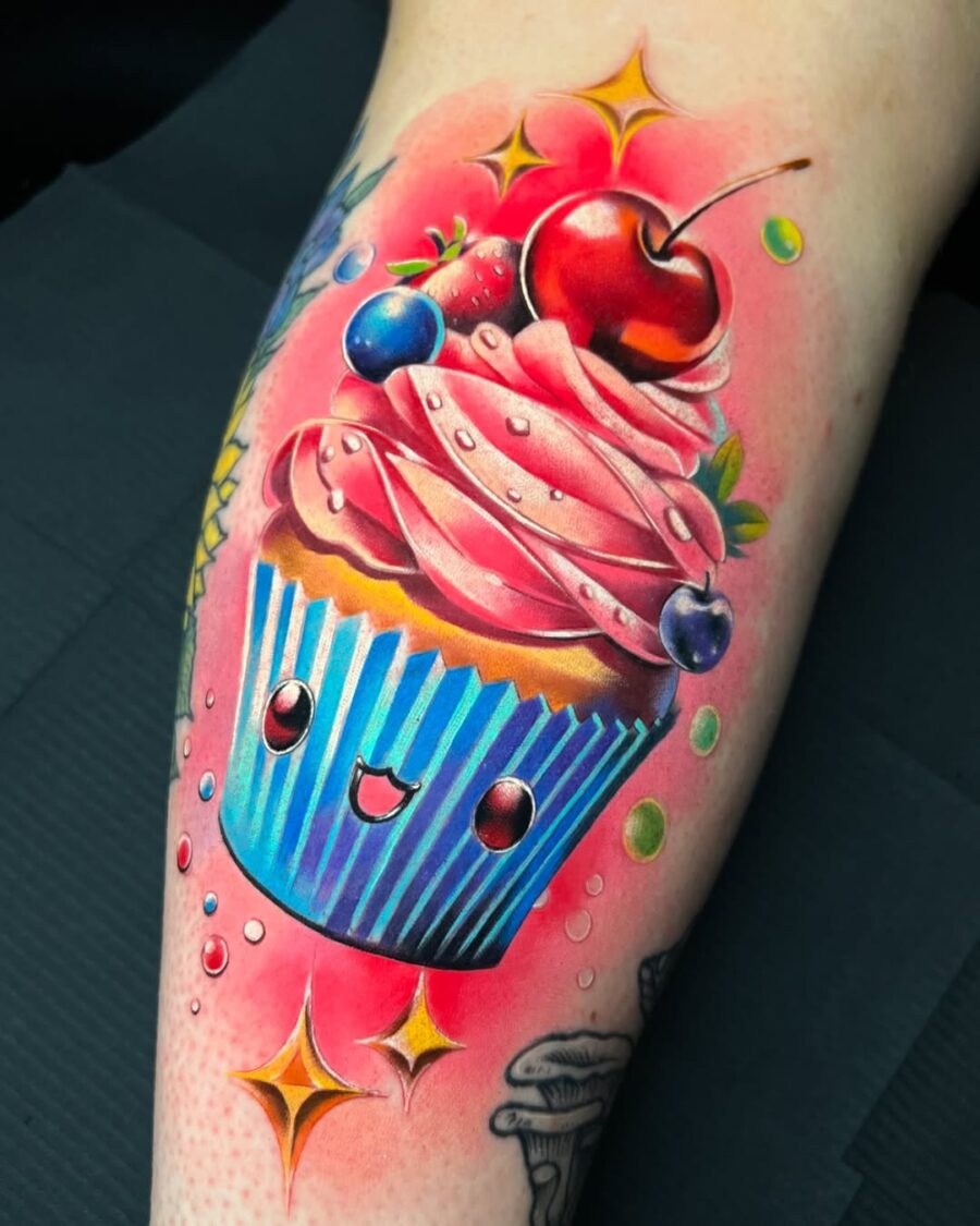 Whimsical cupcake tattoo bursting with color Tattoo on skin