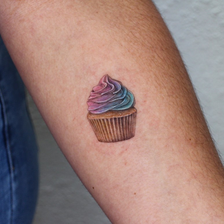 Whimsical cupcake tattoo showcasing vibrant colors Tattoo on skin