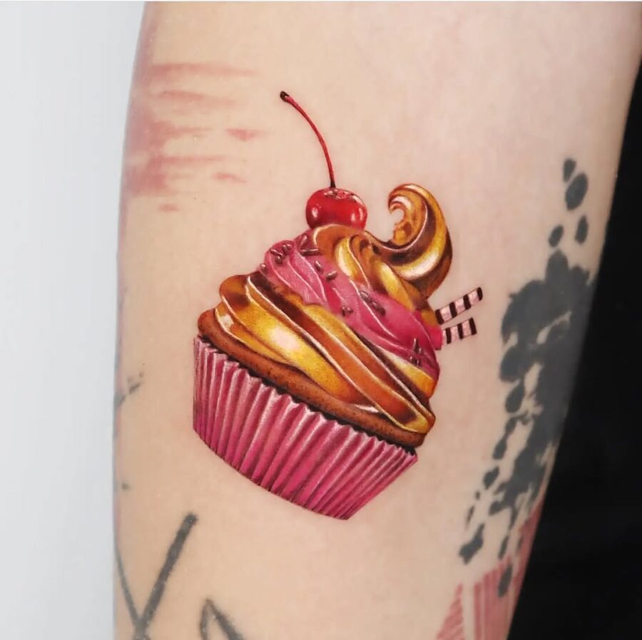 Whimsical cupcake tattoo with cherry on top Tattoo on skin