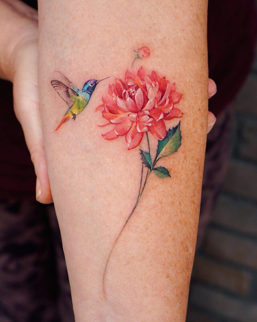 Beautiful dahlia tattoo with hummingbird detail Tattoo on skin