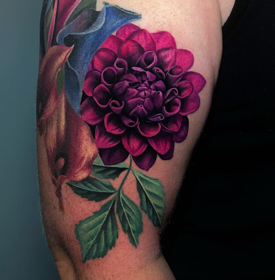 Intricate dahlia tattoo with vibrant hues Tattoo on skin