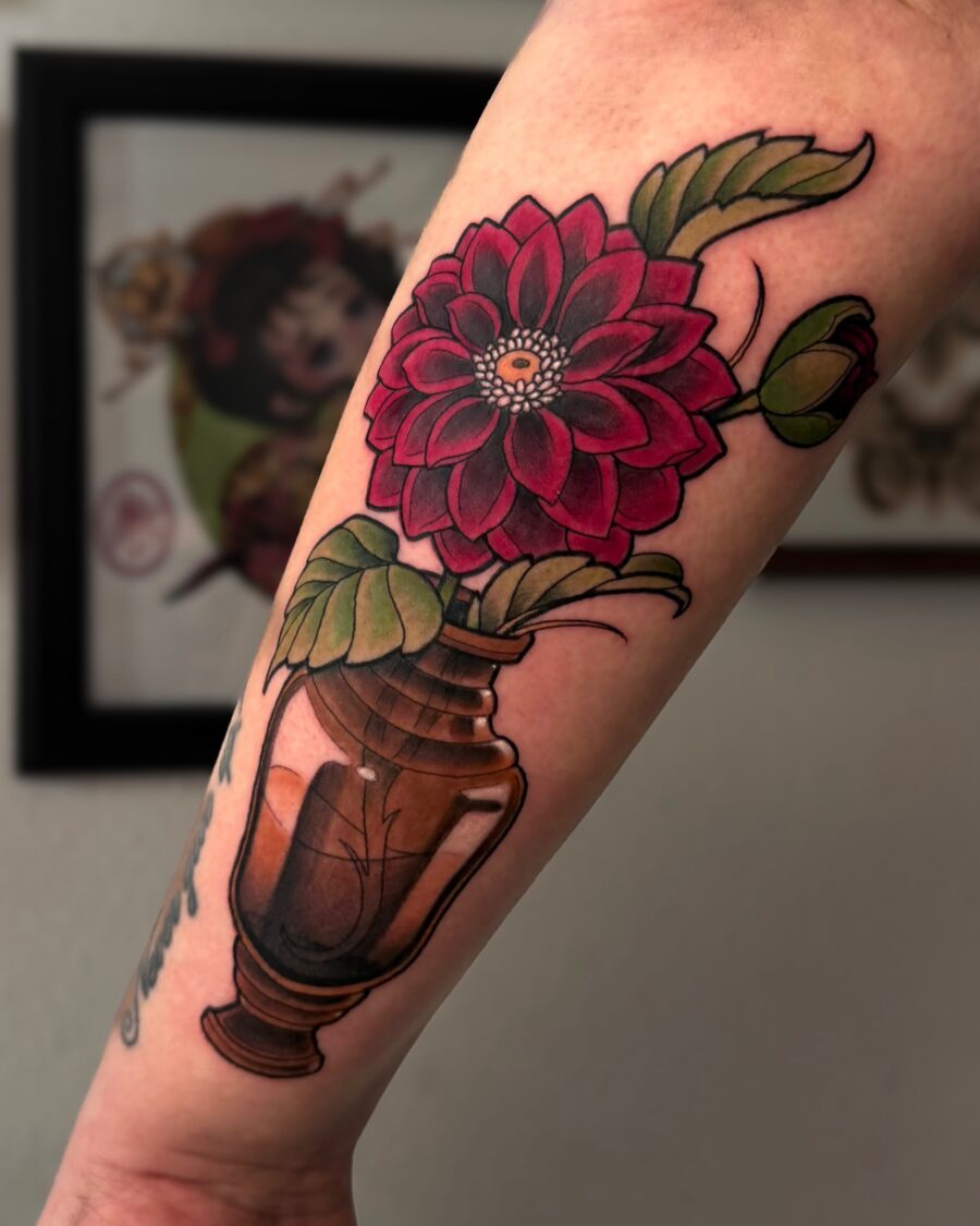 Vibrant dahlia tattoo in a vase design Tattoo on skin