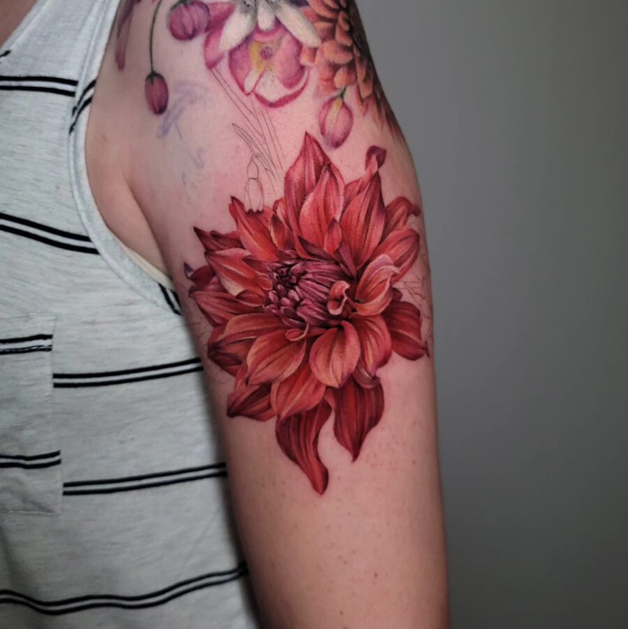 Vibrant dahlia tattoo showcasing rich red hues Tattoo on skin