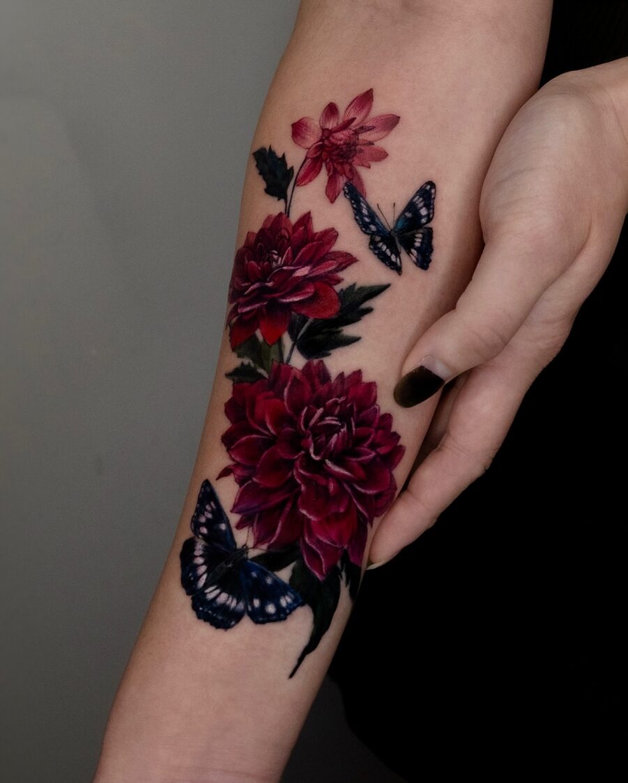 Vibrant dahlias alongside graceful butterflies tattoo Tattoo on skin