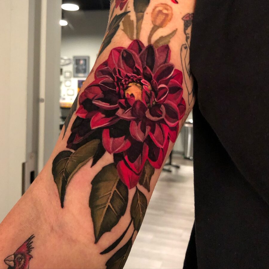Vibrant red dahlia tattoo showcasing floral beauty Tattoo on skin