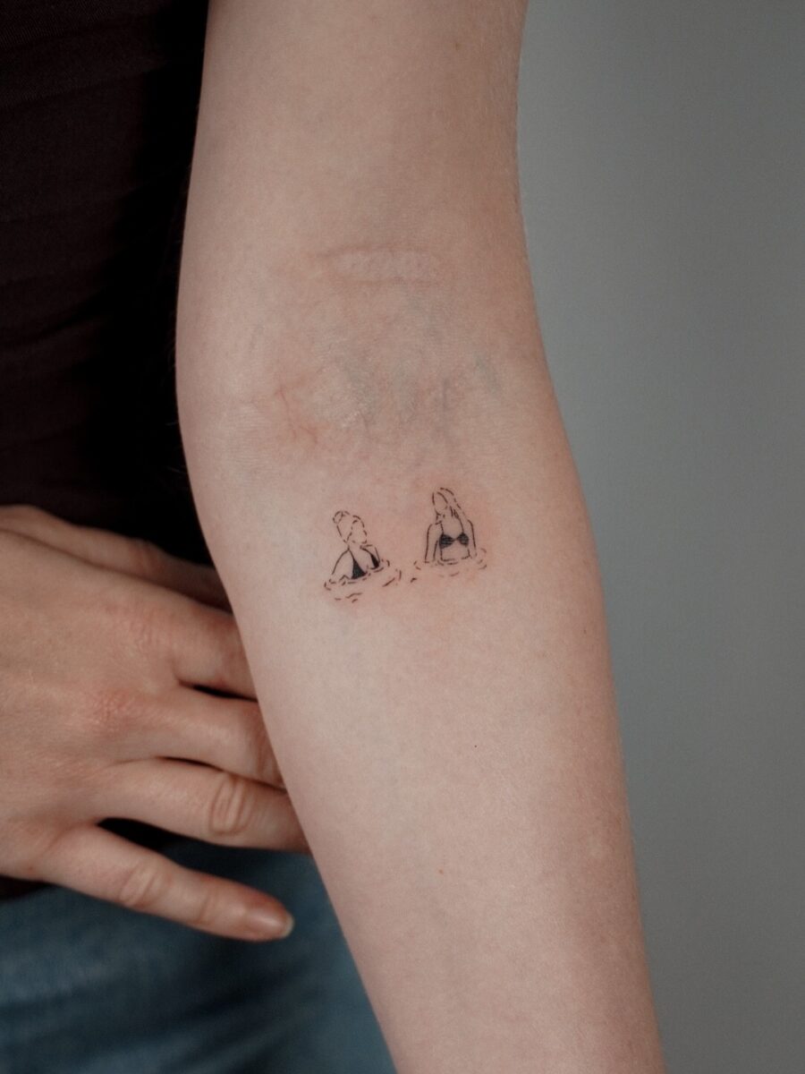 Charming Elbow Tattoo Featuring Two Girls Tattoo on skin