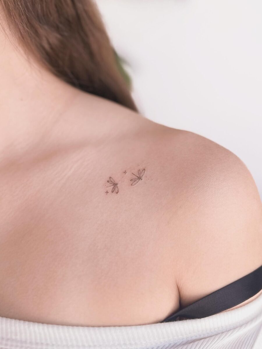 Delicate dragonfly tattoo on shoulder Tattoo on skin