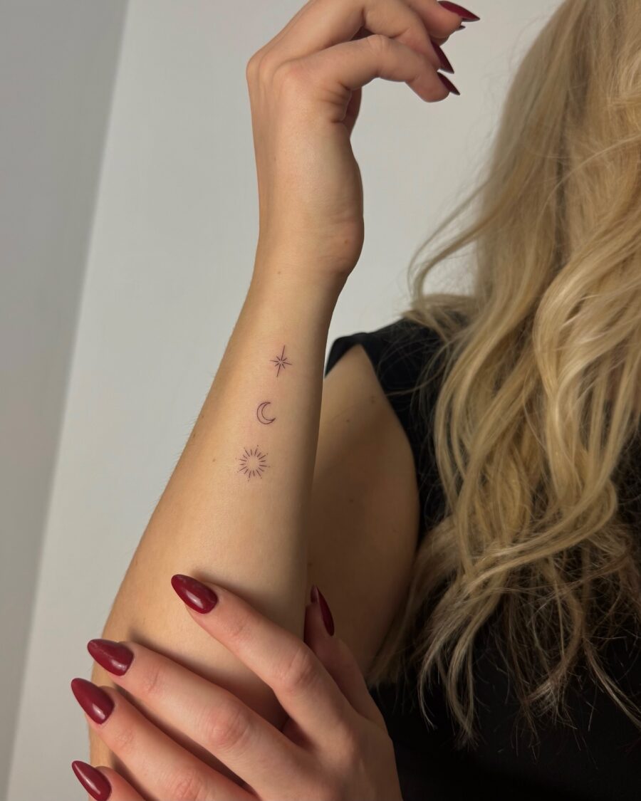 Elegant celestial designs on forearm Tattoo on skin