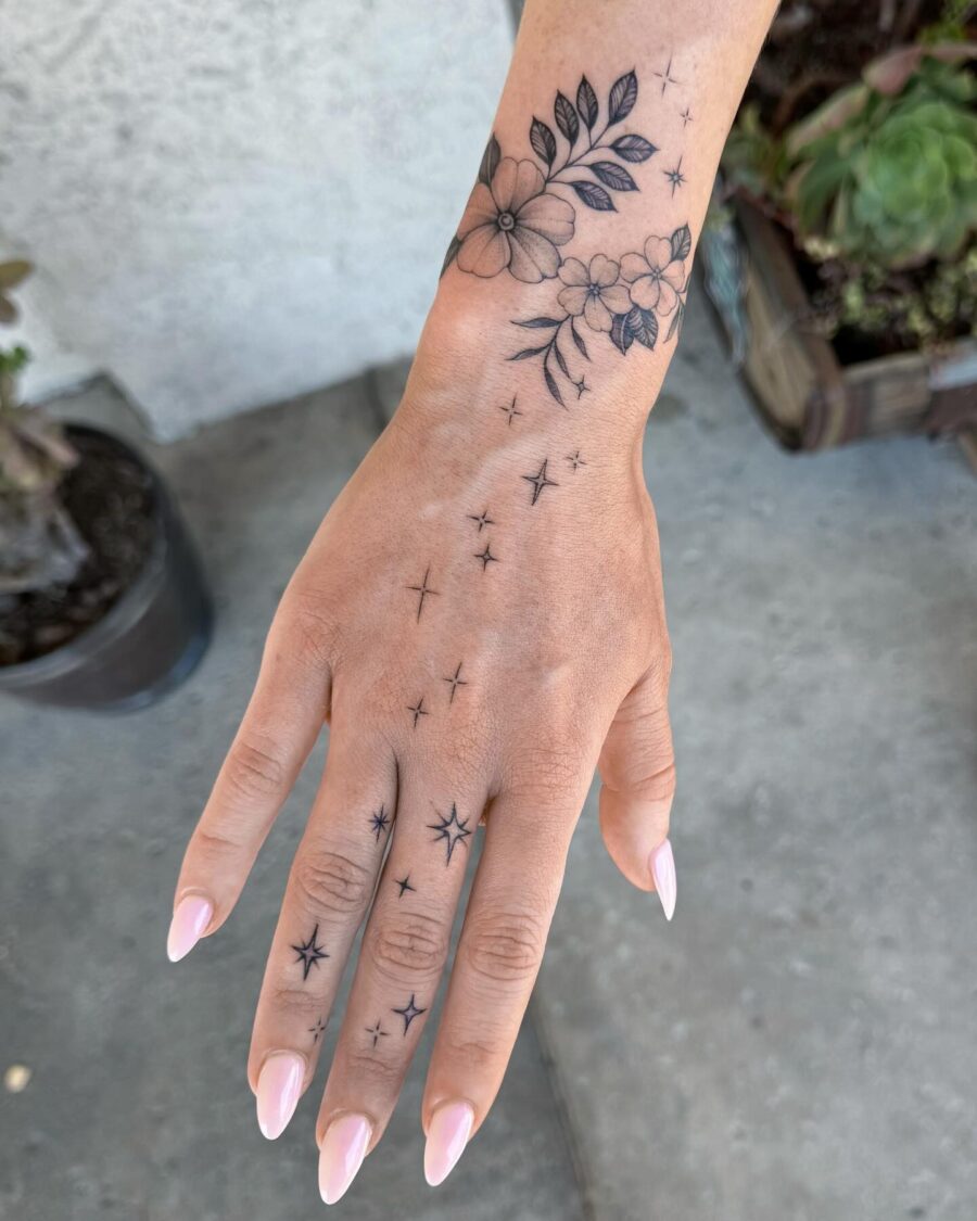Elegant floral and star hand tattoos Tattoo on skin