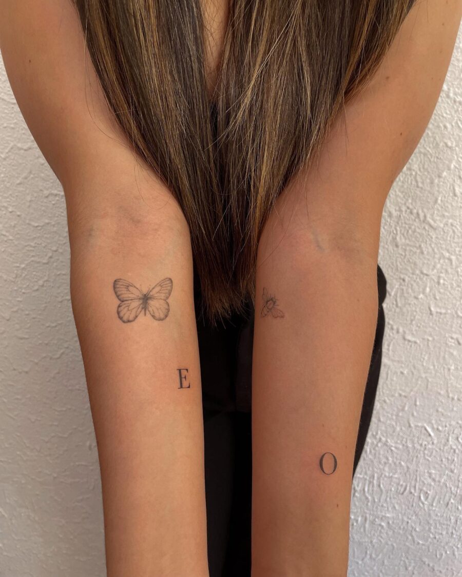 Elegant Tattoos Featuring Butterfly and Initials Tattoo on skin