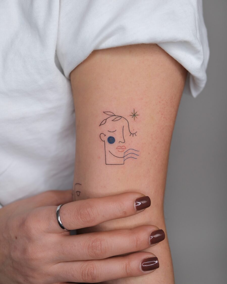 Minimalist face tattoo with artistic flair Tattoo on skin