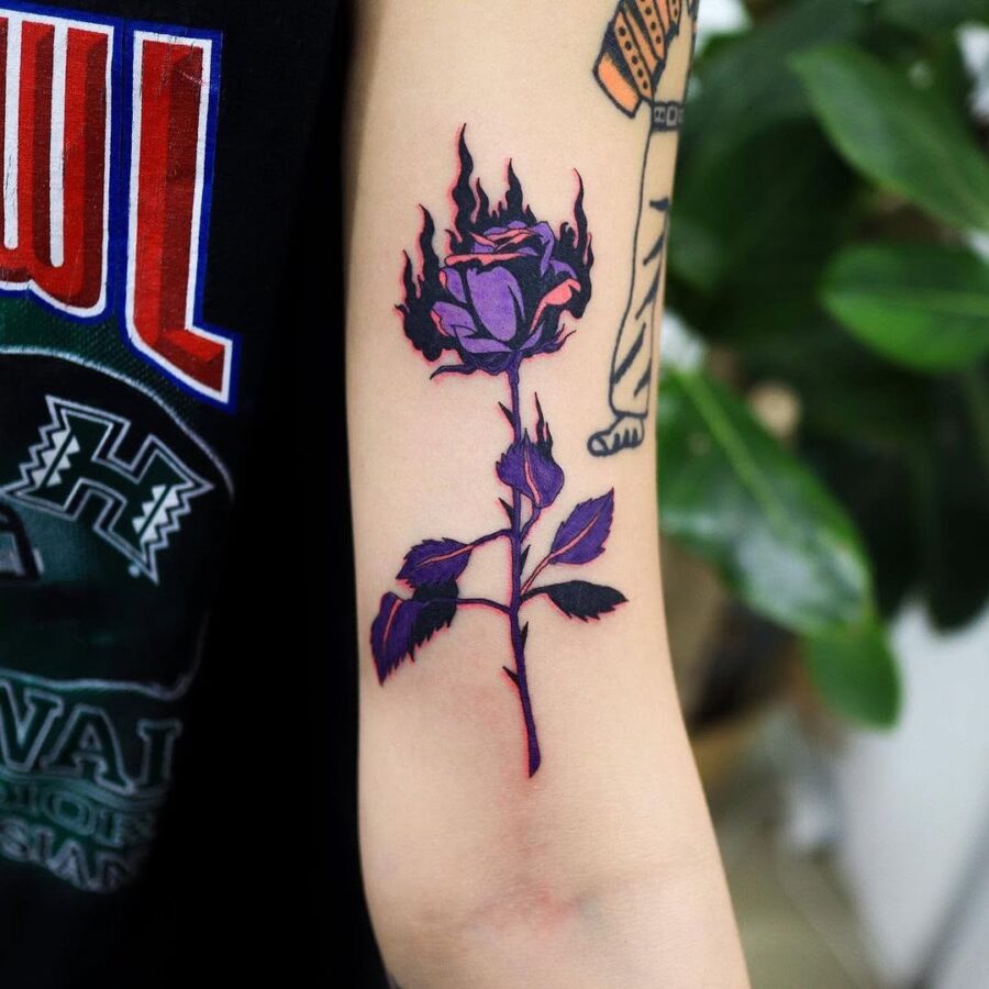A striking rose tattoo adorned with flames Tattoo on skin