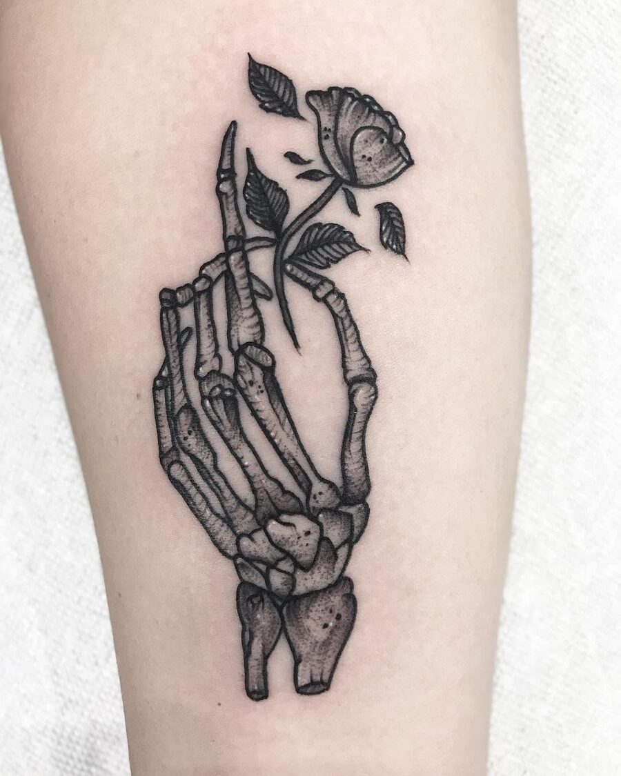 Artful blend of skeleton hand and rose Tattoo on skin