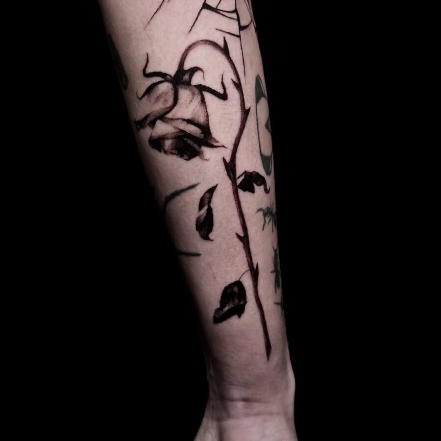 Elegant black and grey dead flower tattoo. Tattoo on skin