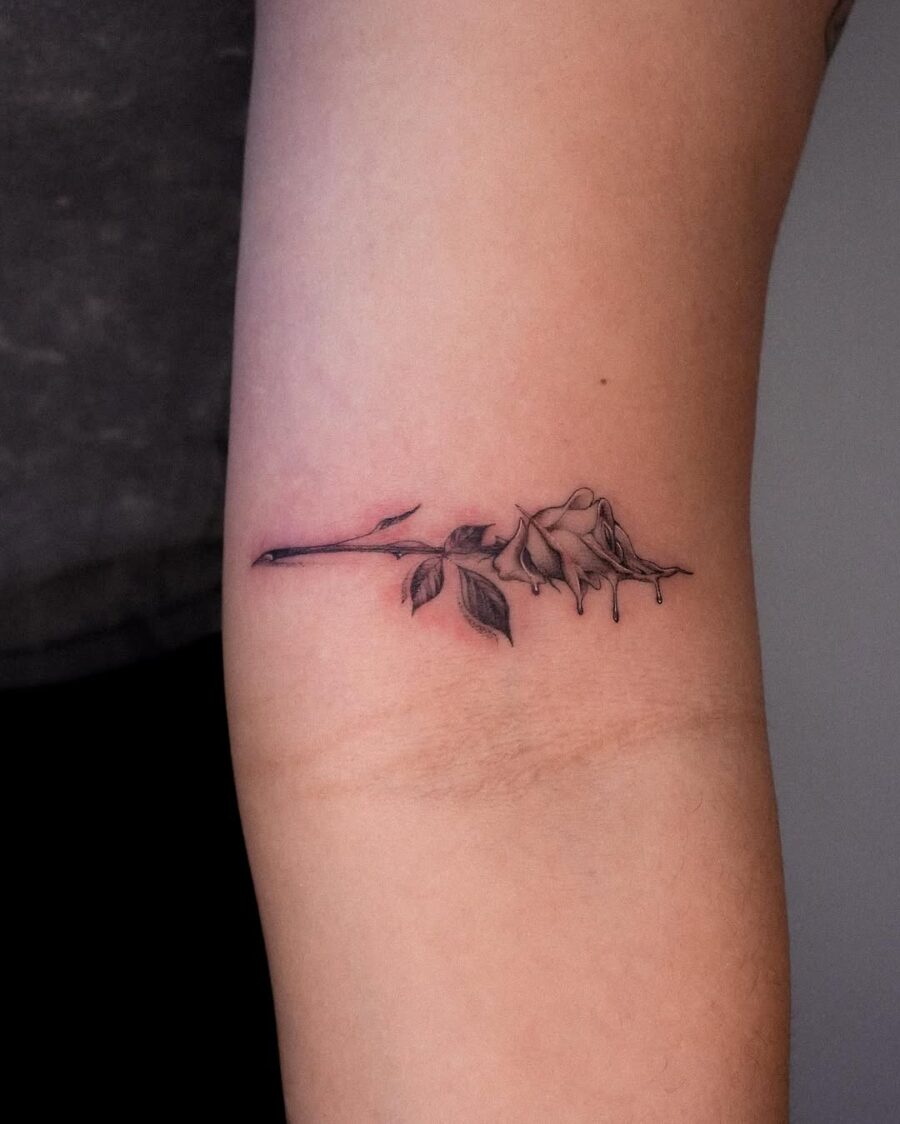 Elegant dead rose tattoo with subtle details Tattoo on skin