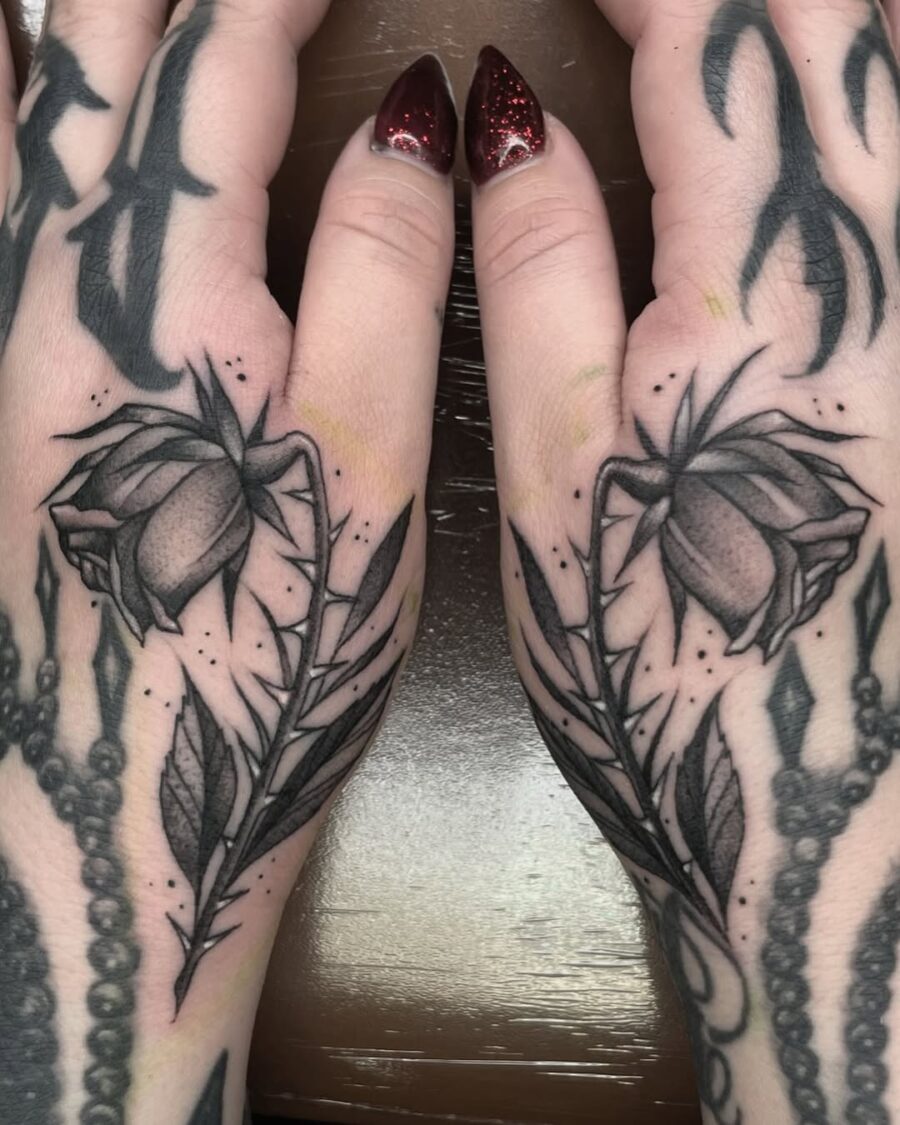Elegant dead roses on hands create striking contrast Tattoo on skin