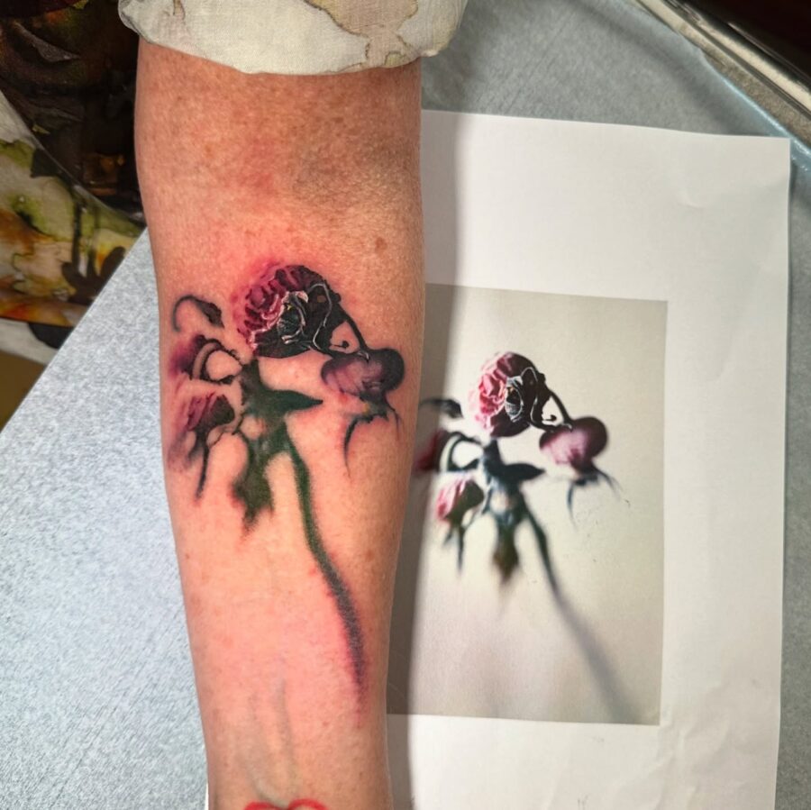 Elegantly decayed floral tattoo on the arm Tattoo on skin